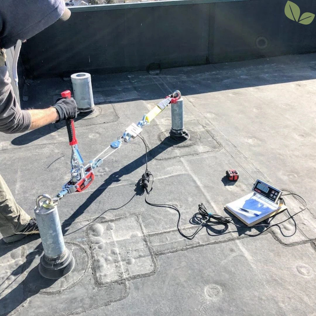 Commercial roof safety anchor undergoing load testing for fall protection compliance