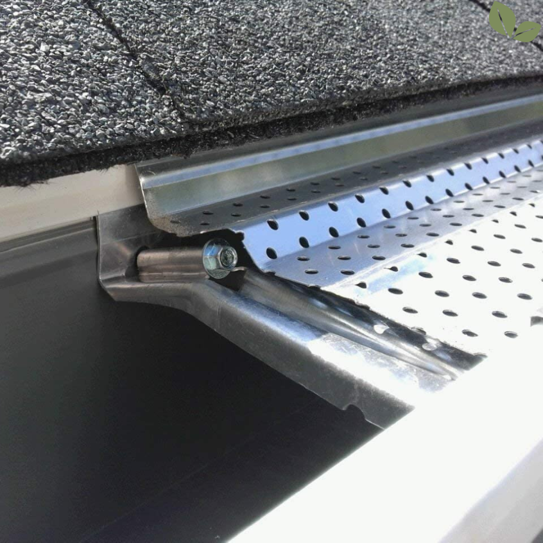 Metal gutter guard installed on roof edge preventing debris buildup